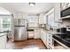 Stainless steel appliances and granite countertops offer a modern touch to the kitchen at 1955 Ingalls St, Lakewood, CO 80214