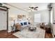Comfortable living room featuring a ceiling fan, stylish decor, and hardwood floors at 1955 Ingalls St, Lakewood, CO 80214