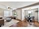 Open-concept living room with hardwood floors, a dining area, and great natural light at 1955 Ingalls St, Lakewood, CO 80214