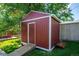 Exterior of shed with ramp and side door nestled between mature trees at 1955 Ingalls St, Lakewood, CO 80214
