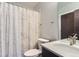 Bathroom with white countertop sink, patterned shower curtain and nickel hardware at 3150 Vallejo St, Denver, CO 80211