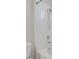 Clean bathroom with white tiled walls, a bathtub-shower, and modern fixtures at 14321 E Tennessee Ave # 1-301, Aurora, CO 80012