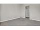 Empty bedroom with neutral walls and carpet flooring, and an open doorway at 14321 E Tennessee Ave # 1-301, Aurora, CO 80012