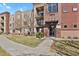 Well-maintained apartment building with brick facade, landscaped grounds, and convenient walkway access at 14321 E Tennessee Ave # 1-301, Aurora, CO 80012