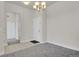 Inviting foyer with tile flooring, neutral paint, and an overhead chandelier at 14321 E Tennessee Ave # 1-301, Aurora, CO 80012