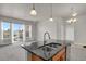 Open-concept kitchen features granite countertops, a kitchen island with a sink, and a view of the balcony at 14321 E Tennessee Ave # 1-301, Aurora, CO 80012
