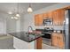 Well-equipped kitchen featuring granite countertops, stainless steel appliances, and ample cabinetry at 14321 E Tennessee Ave # 1-301, Aurora, CO 80012