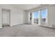 Bright and spacious living room featuring large windows and balcony access, showcasing ample natural light at 14321 E Tennessee Ave # 1-301, Aurora, CO 80012
