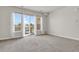 Sun-filled living room featuring balcony access with sliding glass doors and modern finishes at 14321 E Tennessee Ave # 1-301, Aurora, CO 80012