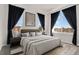 Comfortable bedroom featuring large windows, dark curtains, and a plush bed at 14321 E Tennessee Ave # 1-301, Aurora, CO 80012