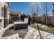 Landscaped backyard featuring a hot tub and a covered patio with an outdoor grill at 10761 Hillsboro Cir, Parker, CO 80134