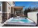 Backyard featuring a hot tub and a patio with an outdoor grill and a fenced yard at 10761 Hillsboro Cir, Parker, CO 80134