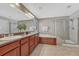 Well-lit primary bathroom with double vanity, granite counters, soaking tub, and a glass-enclosed shower at 10761 Hillsboro Cir, Parker, CO 80134