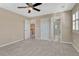 Neutral bedroom featuring a ceiling fan and plush carpet and a view of the bath and upper floor at 10761 Hillsboro Cir, Parker, CO 80134