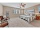 Comfortable bedroom with plush carpet, natural lighting, and coastal decor at 10761 Hillsboro Cir, Parker, CO 80134