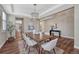 Stylish dining room with hardwood floors, modern chandelier, and neutral decor at 10761 Hillsboro Cir, Parker, CO 80134