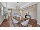 Dining room showcasing hardwood floors, modern table setting, and neutral color palette at 10761 Hillsboro Cir, Parker, CO 80134