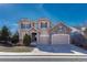 Inviting two-story home with stone accents, a three-car garage, and well-manicured landscaping at 10761 Hillsboro Cir, Parker, CO 80134