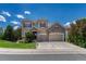 Charming two-story home with a three car garage and lush front lawn at 10761 Hillsboro Cir, Parker, CO 80134