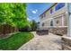 Well-maintained backyard, featuring a hot tub, brick patio, and manicured lawn at 10761 Hillsboro Cir, Parker, CO 80134