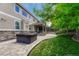 Stone patio featuring a hot tub and covered seating area at 10761 Hillsboro Cir, Parker, CO 80134