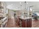 Spacious kitchen flows into a naturally lit living room with views of fireplace at 10761 Hillsboro Cir, Parker, CO 80134