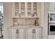 Close-up of kitchen hutch with marble countertops and glass front cabinets at 10761 Hillsboro Cir, Parker, CO 80134