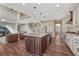 Spacious kitchen island featuring pendant lighting, stainless steel appliances, and hardwood flooring at 10761 Hillsboro Cir, Parker, CO 80134