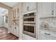 Gourmet kitchen with stainless steel double ovens and custom cabinetry, perfect for cooking enthusiasts at 10761 Hillsboro Cir, Parker, CO 80134