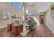 Bright living room with tall windows, stone fireplace, and hardwood flooring at 10761 Hillsboro Cir, Parker, CO 80134