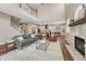 Open-concept living room with fireplace that flows into a gourmet kitchen; great natural lighting at 10761 Hillsboro Cir, Parker, CO 80134