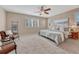 Serene main bedroom with neutral carpet, ceiling fan, and natural light at 10761 Hillsboro Cir, Parker, CO 80134