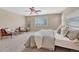 Bright main bedroom featuring neutral walls, carpet, and ceiling fan at 10761 Hillsboro Cir, Parker, CO 80134
