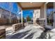 Covered back patio with stone columns offers a beautiful outdoor lounge area with stone accents at 10761 Hillsboro Cir, Parker, CO 80134