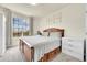 Bedroom with a large window, carpet flooring, queen bed, and matching white dressers at 5714 N Gibralter Way # 5-204, Aurora, CO 80019