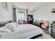 Cozy bedroom with a queen-sized bed, a dark wood dresser, and a window at 5714 N Gibralter Way # 5-204, Aurora, CO 80019