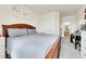 Bedroom showcases a queen bed, carpet, a large walk-in closet, and a view of the bathroom at 5714 N Gibralter Way # 5-204, Aurora, CO 80019