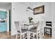 Dining area with seating for six, complemented by a modern chandelier and flowers at 5714 N Gibralter Way # 5-204, Aurora, CO 80019