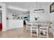 Dining area adjacent to the kitchen, featuring stylish lighting and seating for six at 5714 N Gibralter Way # 5-204, Aurora, CO 80019