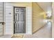 Apartment front door on a secure floor with a digital keypad, welcome mat, and good lighting at 5714 N Gibralter Way # 5-204, Aurora, CO 80019