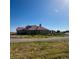 Sprawling single-Gathering home with a beautiful exterior, large yard, and scenic views on a sunny day at 13291 N Harback Rd, Bennett, CO 80102
