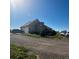 Tan house with an attached garage and an array of vehicles in the driveway at 13291 N Harback Rd, Bennett, CO 80102