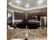 Modern kitchen featuring stainless steel appliances, granite countertops, and dark wood cabinets at 13291 N Harback Rd, Bennett, CO 80102