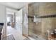 Modern bathroom featuring a glass-enclosed shower and a view of the living room at 1411 Wynkoop St # 806, Denver, CO 80202