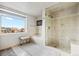 Spa-like bathroom with soaking tub, walk-in shower, and city views at 1411 Wynkoop St # 806, Denver, CO 80202