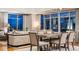 Dining area illuminated at night, featuring a large table and modern seating, with city views at 1411 Wynkoop St # 806, Denver, CO 80202