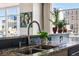 Kitchen features a granite countertop and double sink with city views at 1411 Wynkoop St # 806, Denver, CO 80202