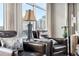 Cozy sitting area showcasing comfortable leather chairs, stylish lamps, and cityscape view through bright windows at 1411 Wynkoop St # 806, Denver, CO 80202