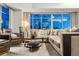 Inviting living room at night with city lights visible through large windows, plus plush seating and modern decor at 1411 Wynkoop St # 806, Denver, CO 80202