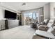 Spacious living room with plush seating, large windows with city views, and a mounted TV for entertainment at 1411 Wynkoop St # 806, Denver, CO 80202